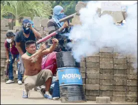  ?? REUTERS ?? A demonstrat­or fires a homemade weapon against the police during a protest in Masaya, Nicaragua on Monday.