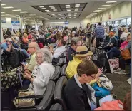  ?? (AP/John Scalzi) ?? Scenes such as this one Saturday at Florida’s Fort Lauderdale-Hollywood Internatio­nal Airport show how travel has been made difficult across the country, disrupting plans for thousands including many Arkansans.