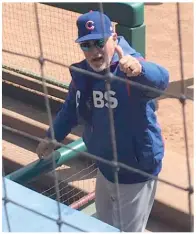  ?? NATE OLSON PHOTOS ?? J.D. Olson shows off a baseball signed and given to him by Cubs manager Joe Maddon before Sunday’s game in Arlington, Texas. Maddon signed the ball “Joe Maddon, WS Champs 2016.”