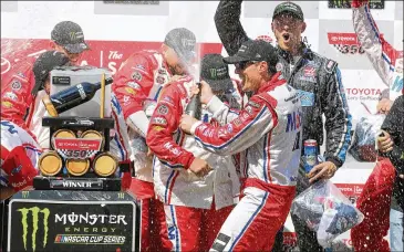  ?? SARAH CRABILL / GETTY IMAGES ?? Driver Kevin Harvick (with bottle) celebrates Sunday’s victory at Sonoma Raceway. The Bakersfiel­d, Calif., native had been 0 for 16 on his home state’s road course track before the win.