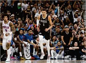  ?? Ronald Cortes/getty Images ?? Spurs center Victor Wembanyama (1) soaks up the cheers after hitting one of his five 3-pointers during Sunday’s 33-point game against the 76ers.