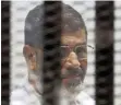  ?? REUTERS ?? FORMER Egyptian president Mohammed Morsi sits behind bars at a court on the outskirts of Cairo, in Egypt, on Wednesday. |