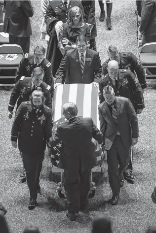  ?? Francisco Kjolseth / Associated Press ?? Jennie Taylor follows the casket of her husband, Maj. Brent R. Taylor, during services Saturday in Ogden, Utah. Taylor, 39, who was the mayor of North Ogden, was slain in Afghanista­n.