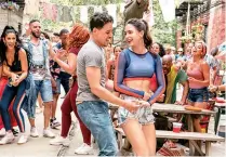  ??  ?? Anthony Ramos (front left) and Melissa Barrera (front right) are in a scene from the film “In the Heights.”