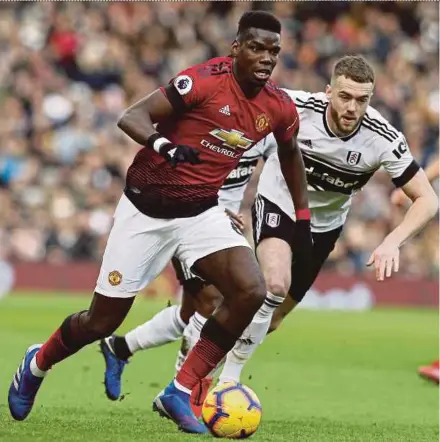  ?? AFP PIC ?? Manchester United’s Paul Pogba (left) goes past Fulham’s Calum Chambers at Craven Cottage yesterday.