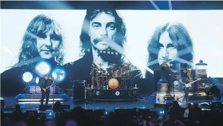  ?? DANNY MOLOSHOK/THE ASSOCIATED PRESS/FILES ?? Alex Lifeson, left, Neil Peart and Geddy Lee of Rush perform in 2013 in Los Angeles as the Canadian band is inducted into the Rock and Roll Hall of Fame. Peart joined Lifeson and Lee in 1974.