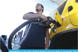  ??  ?? SACRAMENTO: In this photo, Christian Rodriguez fuels his vehicle in Sacramento, Calif. The price of oil has risen by about one-third since the summer, but many experts think the surge won’t last. They point to growing US production. —AP