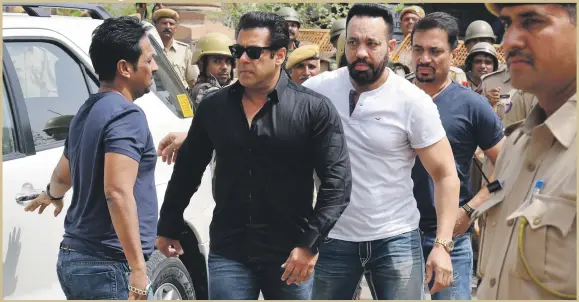  ??  ?? Bollywood actor Salman Khan, second left, arrives at court in Jodhpur, in Rajasthan state, India, on Thursday, where he was convicted of poaching rare deer in a wildlife preserve two decades ago and sentenced to five years in prison. The trial judge...