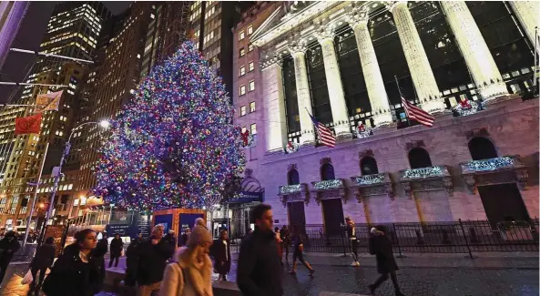  ?? — AFP ?? Good tidings: Christmas decoration­s at the New York Stock Exchange. Asian bourses ended trading yesterday on a positive note after a US-China trade war ceasefire, in tune with Wall Street’s uptrend on Friday.