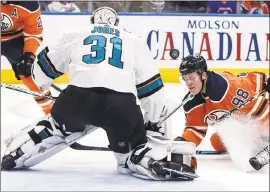  ?? PHOTOS BY JASON FRANSON — CANADIAN PRESS ?? Sharks goalie Martin Jones (31) makes a save against the Oilers’ Jesse Puljujarvi (98) during the second period of Edmonton’s 5-3 win on Monday night.