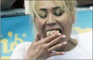  ?? THE ASSOCIATED PRESS ?? Reigning champion Miki Sudo eats hot dogs during the women’s competitio­n of the Nathan’s Famous Fourth of July hot dog eating contest, Wednesday in New York’s Coney Island.