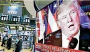  ?? [AP FILE PHOTOS] ?? An image of President-elect Donald Trump appears on a television screen on the floor of the New York Stock Exchange. Lately, markets have been moving sharply either in anticipati­on of policy changes or upon their announceme­nt.