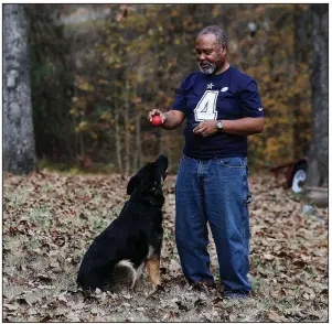  ?? Arkansas Democrat-Gazette/MITCHELL PE MASILUN ?? Darryl Lunon plays fetch with his German shepherd Bibi on his property in Pulaski County on Sunday.