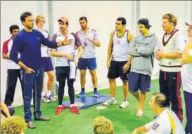  ?? FCC ?? Shalabh Srivastava (left) chats with Fulham Cricket Club players during a training session in Australia.