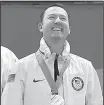  ?? AP/NATACHA PISARENKO ?? John Shuster wears his gold medal after the United States defeated Sweden in men’s curling. The United States team was originally given medals that were designated for the women’s curling gold medalists. The correct medals were swapped out.
