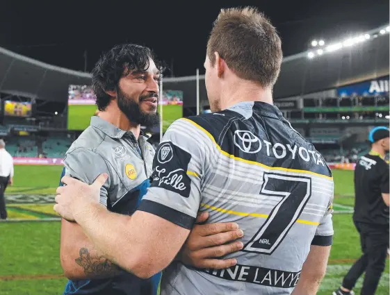  ??  ?? Johnathan Thurston congratula­tes his halfback replacemen­t Michael Morgan after the Cowboys beat the Roosters to qualify for the NRL grand final.