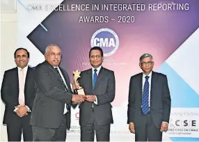  ??  ?? DIMO’s Group CEO, Gahanath Pandithage receiving the Overall Winner award