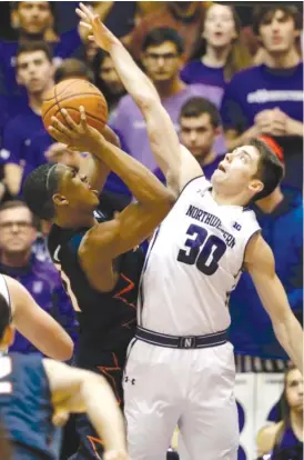  ?? | NAM Y. HUH/AP ?? Northweste­rn guard Bryant McIntosh plays tight defense against Illinois guard Malcolm Hill during the second half Saturday night in Evanston.