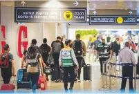  ??  ?? TRAVELERS SEEN in the departure hall at Ben-Gurion Airport yesterday. (Avshalom Sassoni/Flash90)