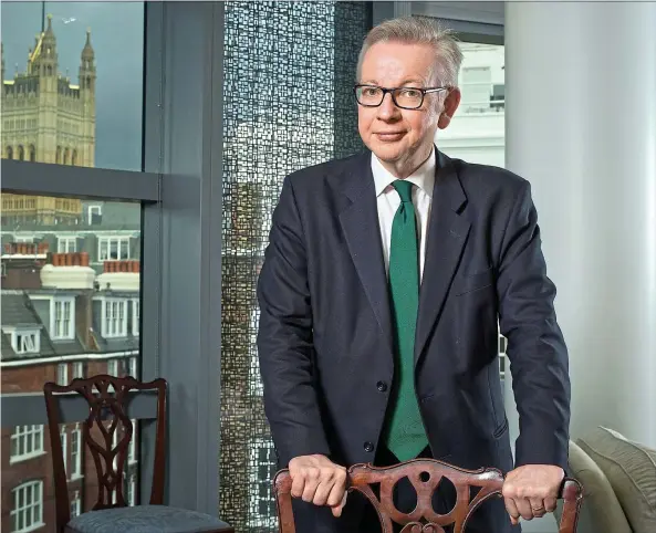  ??  ?? Green machine: Environmen­t Secretary Michael Gove in his office, main. With his wife, journalist Sarah Vine and dog Snowy, below