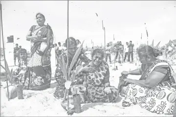  ??  ?? A Sri Lankan Tamil woman reacts as she takes part in a ceremony at Mullaivauk­kal on the outskirts of Jaffna. — AFP photos