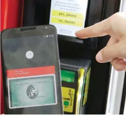  ??  ?? SAN FRANCISCO: A Google employee gives a demonstrat­ion of Android Pay on a phone at Google I/O 2015 in San Francisco. A key reason consumers are hesitant to adopt mobile payments like Apple Pay and Android Pay, surveys say, is fear over security:...