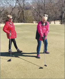  ?? Rick Harvey/Special to The Weekly Vista ?? Henning, left, and Pedziwater, facilitato­rs of the 100-plus member Putt Savers golf group, share a laugh while talking about their group last week at Scotsdale Golf Course.