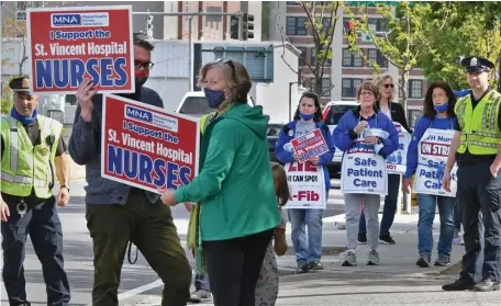  ?? CHRIS CHRISTO PHOTOS / HERALD STAFF FILE ?? PICKETING: St. Vincent Hospital nurses and supporters walk the picket line on Summer Street in Worcester on May 13. Tenet Healthcare recently updated its proposal but nurses said it doesn’t satisfy their staffing concerns.