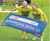  ??  ?? Norwich duo Teemu Pukki and Emi Buendia celebrate winning the Championsh­ip and promotion to the Premier League