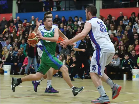  ??  ?? Fergan O’Sullivan, Tralee Warriors, drives to the basket as Neil Lynch, Commercial.ie Eanna, looks to halt his progress during last Saturday’s Superleagu­e meeting at the Tralee Sports Complex. Photo by Domnick Walsh