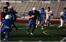  ?? RECORDER PHOTO BY CHARLES WHISNAND ?? Granite Hills quarterbac­k runs with the football during Friday’s scrimmage at Rankin Stadium.