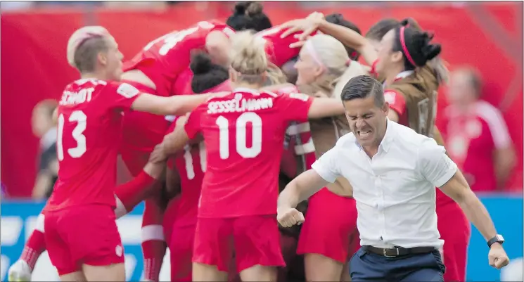  ?? — THE CANADIAN PRESS ?? Coach John Herdman celebrates as Josée Bélanger is mobbed by teammates after scoring against Switzerlan­d in the second half Sunday. Canada won 1-0.