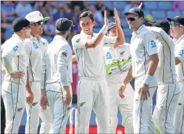  ??  ?? New Zealand's Trent Boult, (c) celebrates the wicket of England's Ben Stokes during their first cricket test in Auckland, New Zealand on Thursday.