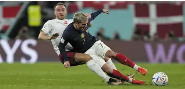  ?? — ap ?? Still going strong: denmark’s Christian eriksen (left) and France’s antoine Griezmann challenge for the ball during their World Cup Group d match.