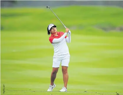  ??  ?? Thidapa Suwannapur­a hits her third shot on the sixth hole during the second round.