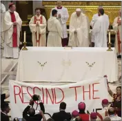  ?? GREGORIO BORGIA — THE ASSOCIATED PRESS ?? People display a banner during Pope Francis Mass at the National Shrine of Saint Anne de Beaupré in Quebec City, Canada, on Thursday, It reads “Rescind the Doctrine.”