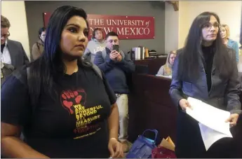  ?? AP PHOTO/RUSSELL CONTRERAS ?? University of New Mexico student LuzHilda Campos (left), and Chicano studies professor Irene Vasquez (right), present a letter with hundreds of signatures Nov. 18 to school president Bob Frank asking him to declare the campus a “sanctuary university,”...