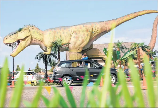  ?? PINNACLE PRODUCTION GROUP ?? Dinosaur Adventure Drive-Thru at the DuPage Fairground­s features more than 80 life-size dinosaurs, include a 40-foot T-Rex.