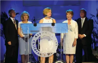  ??  ?? NWA Democrat-Gazette/ANDY SHUPE Marcy Doderer (center), president/CEO of Arkansas Children’s Hospital, speaks Friday, Aug. 7, 2015, to announce a gift of land from David and Cathy Evans (left), and Gary and Robin George (right) to establish a hospital...