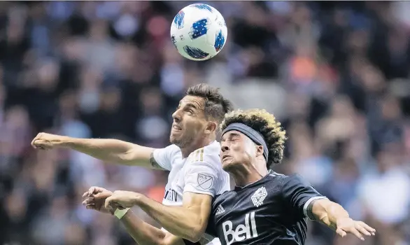  ?? DARRYL DYCK/THE CANADIAN PRESS ?? Los Angeles FC’s Dejan Jakovic, left, and Vancouver Whitecaps’ Erik Hurtado vie for the ball during Friday’s match at B.C. Place, won 2-0 by the visitors.