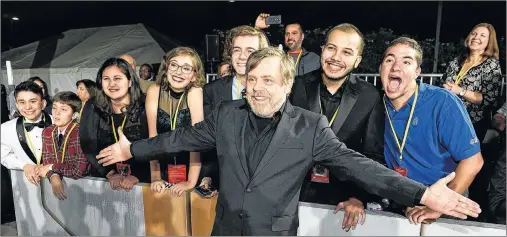  ?? "1 1)050 ?? In this Dec. 9, 2017 photo, “Star Wars: The Last Jedi” cast member Mark Hamill poses with, from left, Jacob Martin, Isaac Rochin, Olivia Sava, Shannon McNabb, Tyler Woodward, Chris Alegria and Max Gavenman at the premiere of the film at the Shrine...