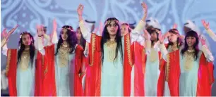  ??  ?? Girls perform a traditiona­l dance during the Nation of Light Operetta at Al Majaz Amphitheat­re.