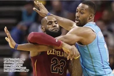  ?? PILIT humuhulagp­os si LeBron James sa depensa ni Dwight Howard sa kainitan ng kanilang laro sa NBA. AP ??