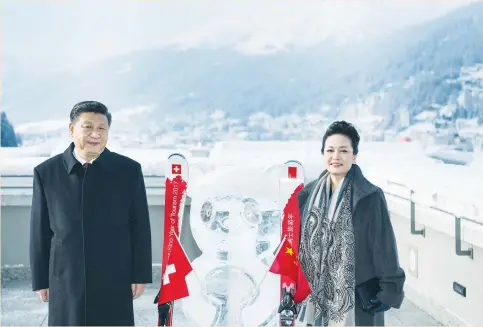  ?? (Reuters) ?? CHINESE PRESIDENT Xi Jinping stands with his wife, Peng Liyuan, next to a panda ice sculpture as they launch the Swiss-Sino year of tourism yesterday on the sidelines of the 47th annual meeting of the World Economic Forum in Davos.