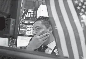  ?? RICHARD DREW / ASSOCIATED PRESS ?? Specialist Ronnie Howard works at his post on the floor of the New York Stock Exchange. Stocks were jolted over the last few weeks of August by rising tensions between the U.S. and North Korea and continuing trouble for the agenda of President Donald...