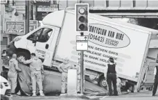  ?? FRANK AUGSTEIN, AP ?? Forensic officers move the van at Finsbury Park in north London, where the vehicle struck pedestrian­s Monday.