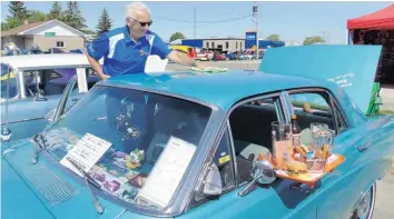  ?? —photo Gregg Chamberlai­n ?? Jack White of Rockland buffs up the roof of his Ford Fairlane 500 after parking it for the day, Sunday morning, during the Annual St-Isidore Car Show, over the June 10 weekend.