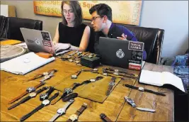  ?? Amir Bibawy ?? The Associated Press Watches sit on a table in May in front of Christian Zeron as he talks with Anna Griffin in Westfield, N.J. Zeron’s company website sells $2 million worth of watches annually.