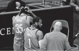  ?? Mark Mulligan / Staff Photograph­er ?? Rockets center Christian Wood (35) attributed Sunday’s dysfunctio­n to poor ball movement, but John Wall disagreed, saying the team needs to hit more shots.