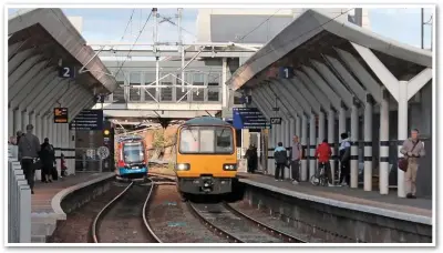  ?? MIKE HADDON. ?? Northern 144001, operating the 1424 Adwick-Sheffield on October 25, arrives at Rotherham Central’s Platform 1, having just passed tram-train 399204 which is on its way to Parkgate as the 1427 from Sheffield Cathedral.